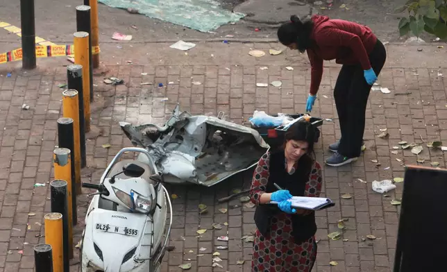 Investigators examine the site of Monday's car explosion near the historic Red Fort, in New Delhi, India, Tuesday, Nov. 11, 2025. (AP Photo)