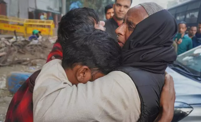 Family members of a victim of Monday's car explosion near the historic Red Fort break down at a hospital in New Delhi, India, Tuesday, Nov. 11, 2025. (AP Photo/Dinesh Joshi)