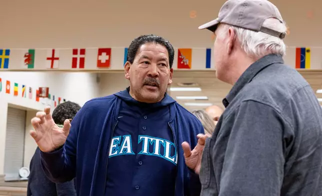Seattle Mayor Bruce Harrell speaks with attendees after a climate forum Thursday, Oct. 16, 2025, in Seattle. (AP Photo/Maddy Grassy)