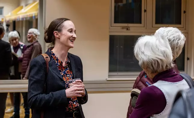 Seattle mayoral candidate Katie Wilson speaks with attendees after a climate forum Thursday, Oct. 16, 2025, in Seattle. (AP Photo/Maddy Grassy)