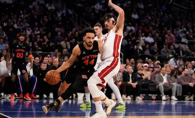 New York Knicks guard Landry Shamet (44) drives past Miami Heat forward Jaime Jaquez Jr. (11) during the first half of an NBA Cup basketball game, Friday, Nov. 14, 2025, in New York. (AP Photo/Yuki Iwamura)