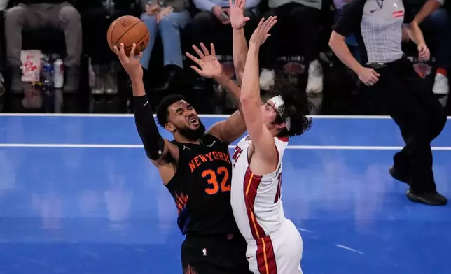 Miami Heat forward Jaime Jaquez Jr. blocks New York Knicks center Karl-Anthony Towns (32) during the first half of an NBA Cup basketball game, Friday, Nov. 14, 2025, in New York. (AP Photo/Yuki Iwamura)
