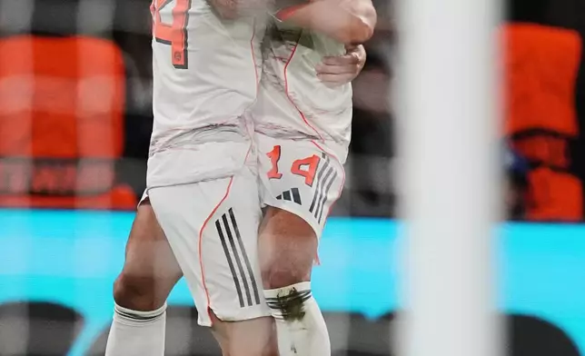 Bayern's Luis Diaz celebrates with team mate Bayern's Josip Stanisic after scoring his side's second goal during the Champions League opening phase soccer match between Paris Saint-Germain and Bayern Munich in Paris, France, Tuesday, Nov. 4, 2025. (AP Photo/Thibault Camus)
