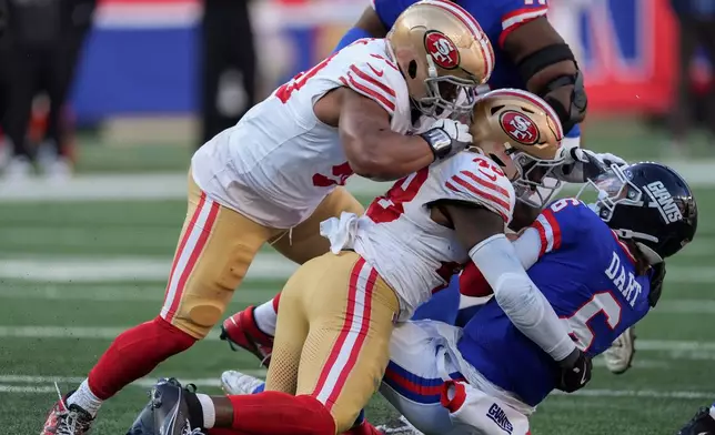New York Giants quarterback Jaxson Dart (6) is tackled by San Francisco 49ers linebacker Tatum Bethune (48) during the third quarter of an NFL football game, Sunday, Nov. 2, 2025, in East Rutherford, N.J. (AP Photo/Seth Wenig)