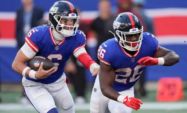 New York Giants quarterback Jaxson Dart (6) carries the ball for a touchdown as running back Devin Singletary (26) blocks against the San Francisco 49ers during the fourth quarter of an NFL football game, Sunday, Nov. 2, 2025, in East Rutherford, N.J. (AP Photo/Seth Wenig)
