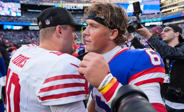 San Francisco 49ers quarterback Mac Jones (10) and New York Giants quarterback Jaxson Dart (6) meet on the field after playing in an NFL football game, Sunday, Nov. 2, 2025, in East Rutherford, N.J. (AP Photo/Seth Wenig)