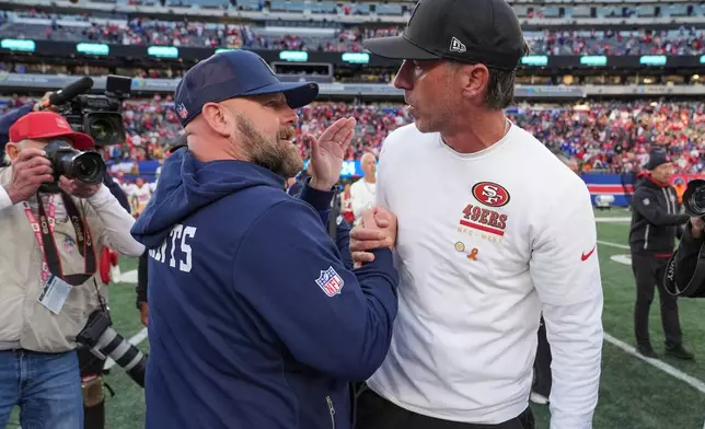 New York Giants head coach Brian Daboll, left, greets San Francisco 49ers head coach Kyle Shanahan after an NFL football game, Sunday, Nov. 2, 2025, in East Rutherford, N.J. (AP Photo/Frank Franklin II)
