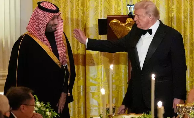 President Donald Trump and Saudi Arabia's Crown Prince Mohammed bin Salman prepare to take their seats during a dinner in the East Room of the White House, Tuesday, Nov. 18, 2025, in Washington. (AP Photo/Alex Brandon)