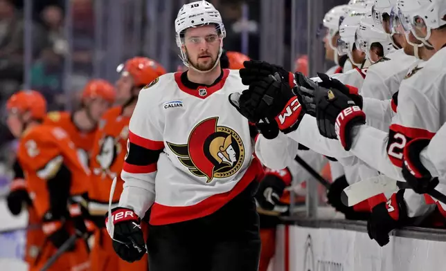 CORRECTS TO THIRD PERIOD - Ottawa Senators right wing Drake Batherson is congratulated after scoring the winning goal during the third period of an NHL hockey game against the Anaheim Ducks, Thursday, Nov. 20, 2025, in Anaheim, Calif. (AP Photo/Jayne Kamin-Oncea)
