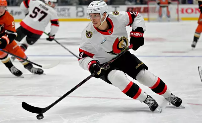 Ottawa Senators center Dylan Cozens handles the puck during the third period of an NHL hockey game against the Anaheim Ducks, Thursday, Nov. 20, 2025, in Anaheim, Calif. (AP Photo/Jayne Kamin-Oncea)