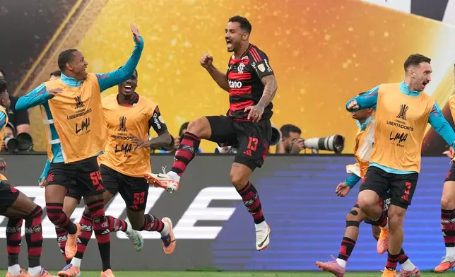 Danilo of Brazil's Flamengo, center, celebrates after scoring his side's opening goal against Brazil's Palmeiras during a Copa Libertadores final soccer match in Lima, Peru, Saturday, Nov. 29, 2025. (AP Photo/Martin Mejia)
