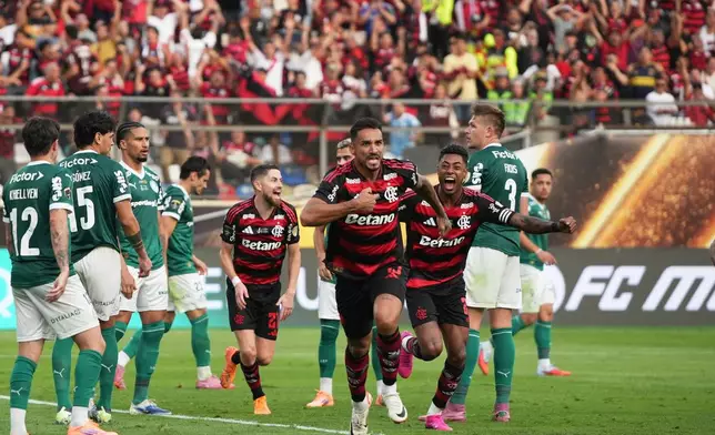 Danilo of Brazil's Flamengo, center, celebrates after scoring his side's opening goal against Brazil's Palmeiras during a Copa Libertadores final soccer match in Lima, Peru, Saturday, Nov. 29, 2025. (AP Photo/Guadalupe Pardo)