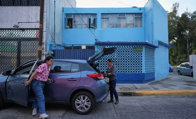 Diana Guzman, left, a driver with the feminist transportation collective AmorrAs, and passenger Ninfa Fuentes, right, arrive at Fuentes' home in the State of Mexico, Thursday, Nov. 6, 2025. (AP Photo/Claudia Rosel)