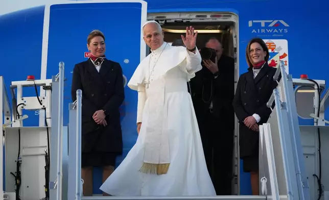Pope Leo XIV boards a plane in Rome's Fiumicino airport on his way to Turkey and Lebanon, Thursday, Nov. 27, 2025. (AP Photo/Alessandra Tarantino)