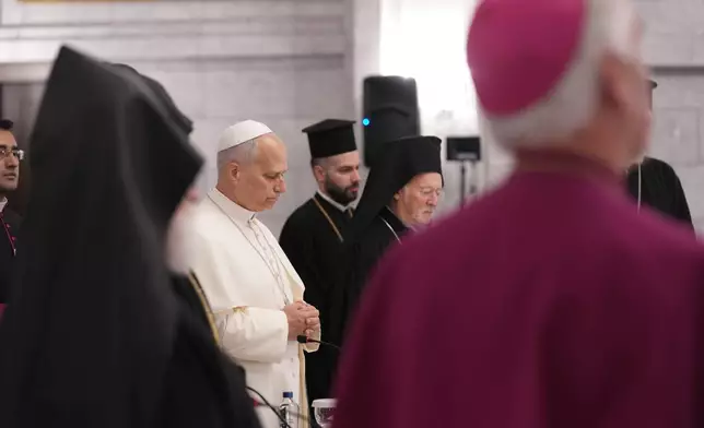 Pope Leo XIV, center, prays during a meeting with the leaders of the local churches and Christian communities at the Syriac Orthodox Church of Mor Ephrem in Istanbul, Turkey, Saturday, Nov. 29, 2025. (AP Photo/Domenico Stinellis)