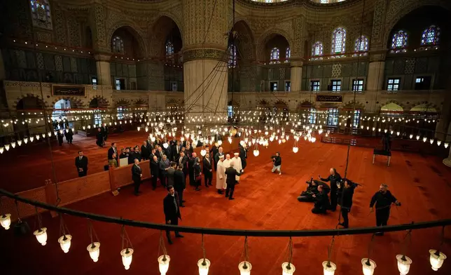 Pope Leo XIV visits the Ottoman-era Sultan Ahmed or Blue Mosque, in Istanbul, Turkey, Saturday, Nov. 29, 2025. (AP Photo/Emrah Gurel)