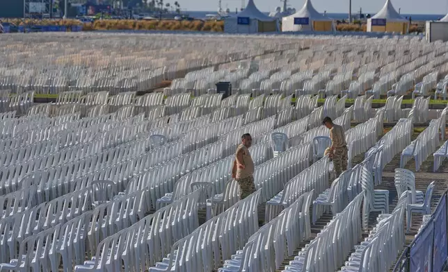 Lebanese army soldiers set chairs in preparation of the area where Pope Leo XIV will hold a Holy mass during his visit to Lebanon, at the waterfront of downtown Beirut, Thursday, Nov. 27, 2025. (AP Photo/Hussein Malla)