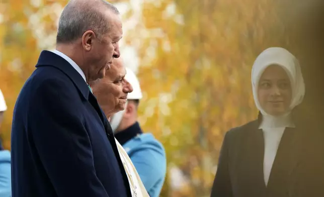 Pope Leo XIV is flanked by Turkish President Recep Tayyip Erdogan as he arrives at the Presidential Palace in Ankara, Turkey, Thursday, Nov. 27, 2025. (AP Photo/Domenico Stinellis)