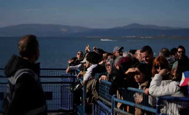 People gather before the arrival of Pope Leo XIV to the archaeological excavations of the ancient Byzantine-era Christian Saint Neophytos Basilica, in Iznik, Turkey, Friday, Nov. 28, 2025. (AP Photo/Khalil Hamra)