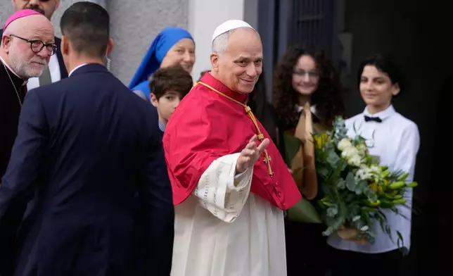 Pope Leo XIV waves to the people as he arrives to the Cathedral of the Holy Spirit, in Istanbul, Turkey, Friday, Nov. 28, 2025, during his first foreign trip. (AP Photo/Emrah Gurel)