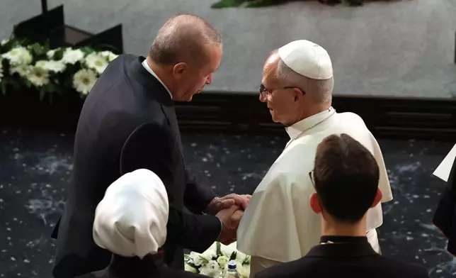 Pope Leo XIV, right, talks to Turkey's President Recep Tayyip Erdogan during a meeting with authorities, members of the civil society and diplomats in the Presidential Palace's national library, in Ankara, Turkey, Thursday, Nov. 27, 2025. (Yavuz Ozden/Dia Photo via AP)
