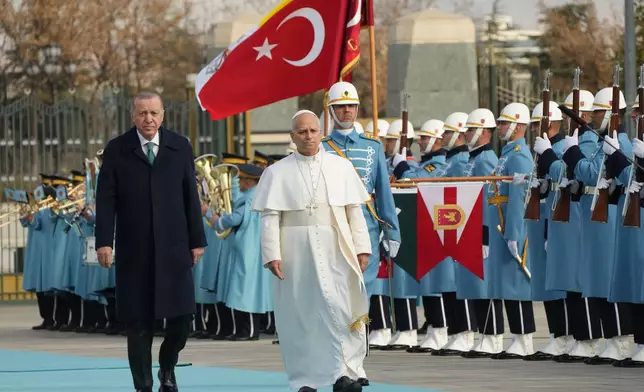 Pope Leo XIV is flanked by Turkish President Recep Tayyip Erdogan as he arrives at the Presidential Palace in Ankara, Turkey, Thursday, Nov. 27, 2025. (AP Photo/Domenico Stinellis)