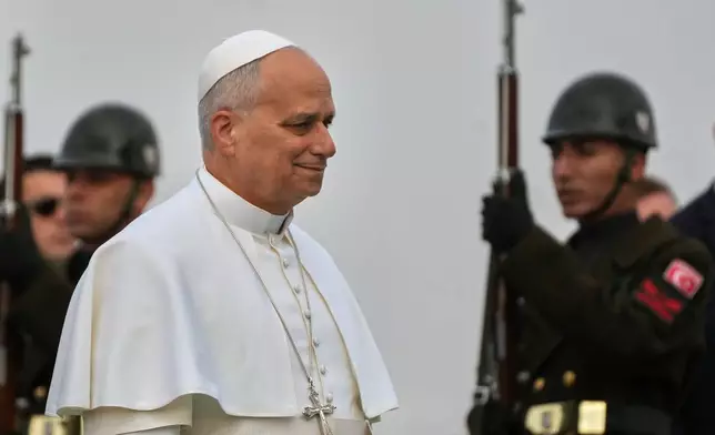 Pope Leo XIV reviews a honor guard as he arrives at the Esenboga international airport in Ankara, Turkey, Thursday, Nov. 27, 2025. (AP Photo/Domenico Stinellis)