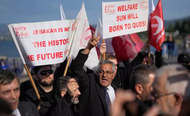 People shout slogans during a small protest by Islamic New Welfare Party against a prayer ceremony led by Pope Leo XIV at the archaeological excavations of the ancient Byzantine-era Christian Saint Neophytos Basilica, in Iznik, Turkey, Friday, Nov. 28, 2025. (AP Photo/Khalil Hamra)