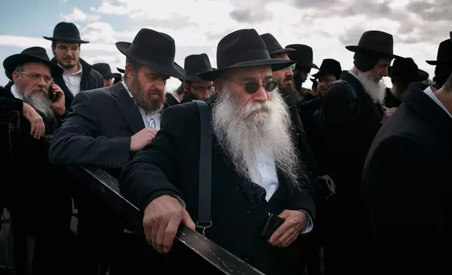 Chabad-Lubavitch rabbis gather in prayer at the resting place of the Rebbe, Rabbi Menachem M. Schneerson, one of Judaism’s most influential figures, in the Queens borough of New York on Friday, Nov. 14, 2025, during the International Conference of Chabad-Lubavitch Emissaries. (AP Photo/Andres Kudacki)