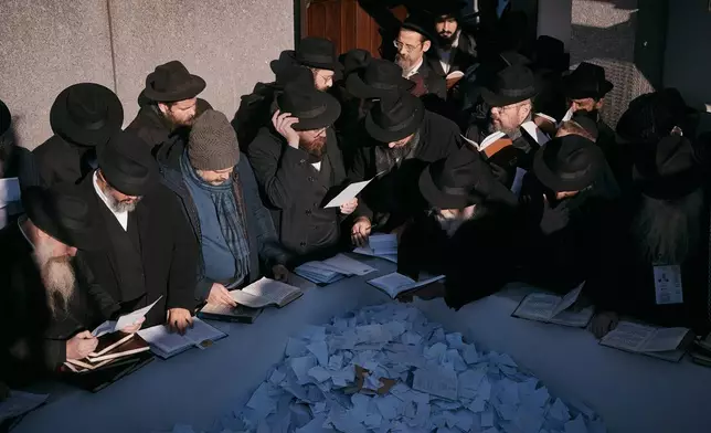 Chabad-Lubavitch rabbis gather in prayer at the resting place of the Rebbe, Rabbi Menachem M. Schneerson, one of Judaism’s most influential figures, in the Queens borough of New York on Friday, Nov. 14, 2025, during the International Conference of Chabad-Lubavitch Emissaries. (AP Photo/Andres Kudacki)