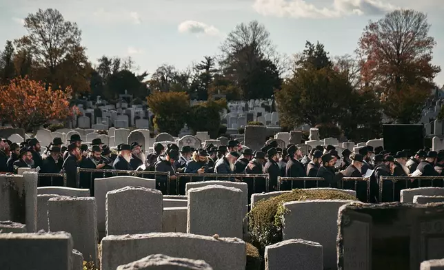 Chabad-Lubavitch rabbis gather in prayer at the resting place of the Rebbe, Rabbi Menachem M. Schneerson, one of Judaism’s most influential figures, in the Queens borough of New York on Friday, Nov. 14, 2025, during the International Conference of Chabad-Lubavitch Emissaries. (AP Photo/Andres Kudacki)