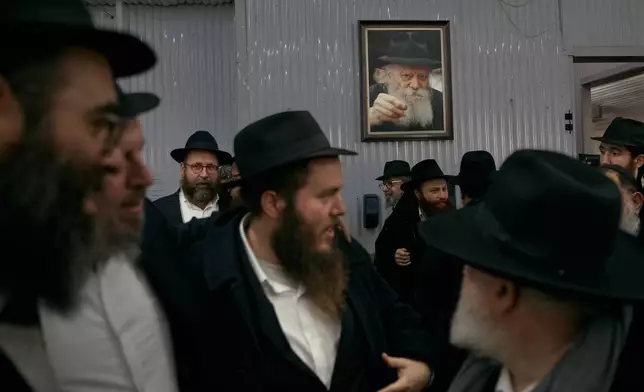 Chabad-Lubavitch rabbis gather at the resting place of the Rebbe, Rabbi Menachem M. Schneerson, one of Judaism’s most influential figures, in the Queens borough of New York on Friday, Nov. 14, 2025, during the International Conference of Chabad-Lubavitch Emissaries. (AP Photo/Andres Kudacki)