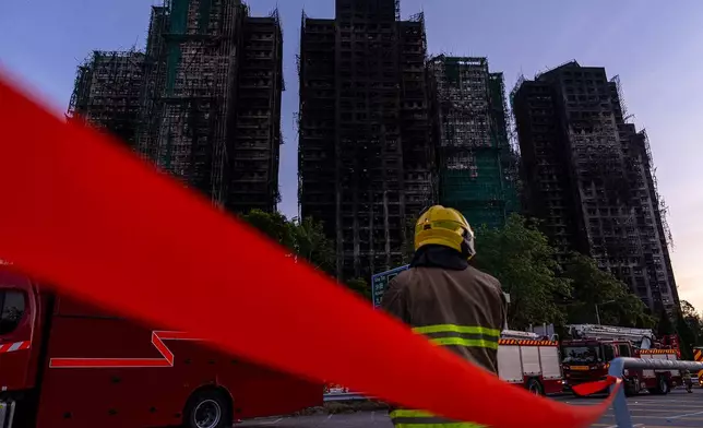 Burned buildings stand in the aftermath of a fire at Wang Fuk Court, a residential estate in the Tai Po district of Hong Kong's New Territories, Friday, Nov. 28, 2025. (AP Photo/Chan Long Hei)