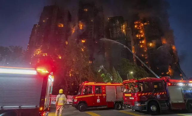 Firefighters work to extinguish a fire which broke out at Wang Fuk Court, a residential estate in the Tai Po district of Hong Kong's New Territories, Wednesday, Nov. 26 2025. (AP Photo/Chan Long Hei)