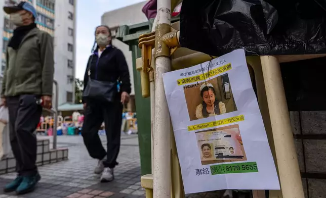 A missing person notice is hanged near the fire scene at Wang Fuk Court, a residential estate in the Tai Po district of Hong Kong's New Territories, Friday, Nov. 28 2025. (AP Photo/Chan Long Hei)