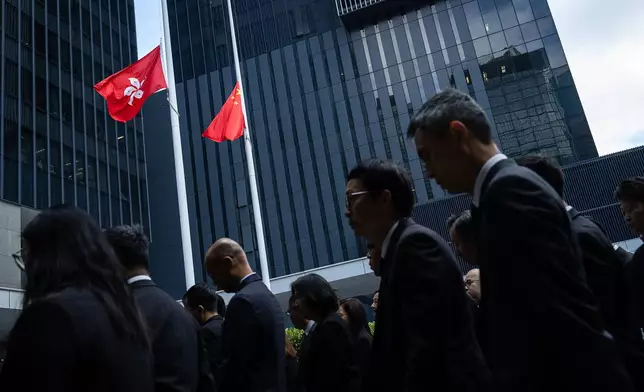 Chinese and Hong Kong Special Administrative Region flags fly at half-mast to mourn the victims of the deadly fire that started Wednesday at Wang Fuk Court, a residential estate in the Tai Po district of Hong Kong's New Territories, Saturday, Nov. 29, 2025. (AP Photo/Chan Long Hei)