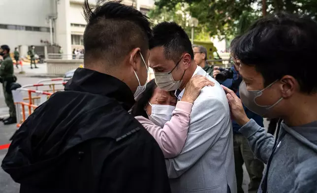 People with missing family members react after checking photographs of the deceased at the fire scene at Wang Fuk Court, a residential estate in the Tai Po district of Hong Kong's New Territories, Thursday, Nov. 27 2025. (AP Photo/Chan Long Hei)