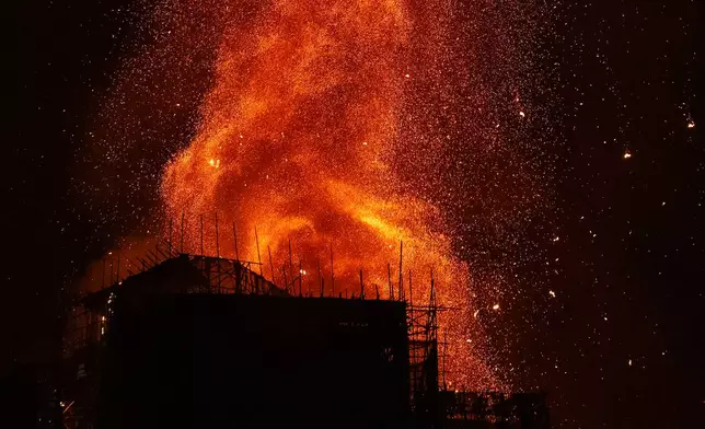Flames engulf a building after a fire broke out at Wang Fuk Court, a residential estate in the Tai Po district of Hong Kong's New Territories, Wednesday, Nov. 26 2025. (AP Photo/Chan Long Hei)