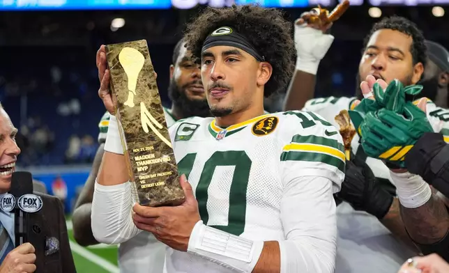 Green Bay Packers quarterback Jordan Love (10) holds the Madden Thanksgiving MVP trophy following an NFL football game against the Detroit Lions in Detroit, Thursday, Nov. 27, 2025. (AP Photo/Ryan Sun)