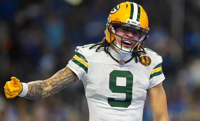 Green Bay Packers wide receiver Christian Watson (9) celebrates a touchdown against the Detroit Lions during the second half an NFL football game in Detroit, Thursday, Nov. 27, 2025. (AP Photo/Ryan Sun)