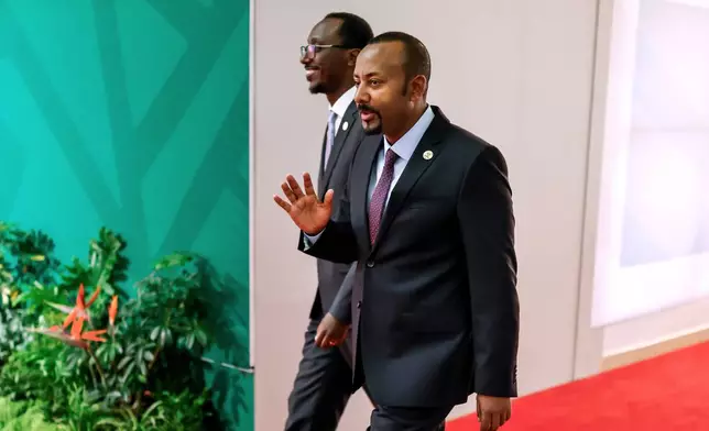 Ethiopia's Prime Minister Abiy Ahmed Ali, foreground, arrives for the second day of the G20 Leaders' Summit, in Johannesburg, South Africa, Sunday, Nov. 23, 2025. (Marco Longari/Pool Photo via AP)