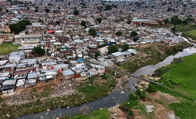 An aerial view of the Jukskei River in the Alexandra township in Johannesburg, South Africa, Wednesday, Nov. 12, 2025. (AP Photo/Nqobile Ntshangase)