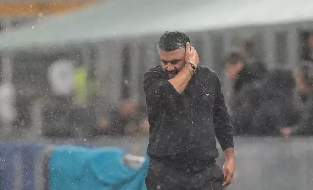 Italy's head coach Gennaro Gattuso walks under the rain before the start of the 2026 World Cup Group I qualifier soccer match between Italy and Norway in Milan, Italy, Sunday, Nov. 16, 2025. (AP Photo/Luca Bruno)