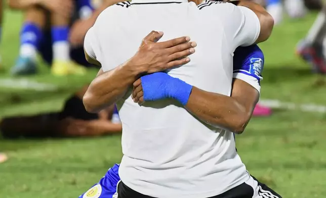 Curaçao players celebrate qualifying for the 2026 FIFA World Cup after a soccer match against Jamaica in Kingston, Jamaica, Tuesday, Nov. 18, 2025. (AP Photo/Collin Reid)