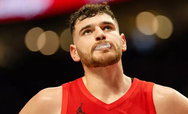 Portland Trail Blazers center Donovan Clingan looks up at the scoreboard during the first half of an Emirates NBA Cup basketball game against the San Antonio Spurs, Wednesday, Nov. 26, 2025, in Portland, Ore. (AP Photo/Ali Gradischer)