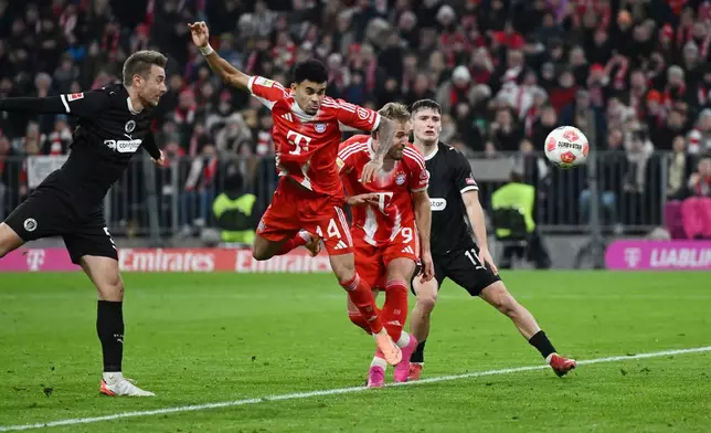 Bayern Munich's Luis Díaz, center, scores during the Bundesliga soccer match between Bayern Munich and FC St. Pauli in Munich, Germany, Saturday Nov. 29, 2025. (Sven Hoppe/dpa via AP)