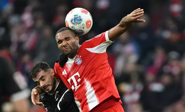 Bayern Munich's Jonathan Tah and St. Pauli's Danel Sinani, left, in action during the Bundesliga soccer match between Bayern Munich and FC St. Pauli in Munich, Germany, Saturday Nov. 29, 2025. (Sven Hoppe/dpa via AP)
