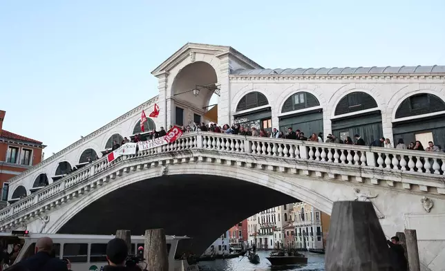 Workers and orchestra members of Venice’s La Fenice theater, joined by other performing arts professionals, march through the city demanding the resignation of superintendent Nicola Colabianchi and artistic director Beatrice Venezi, in Venice, Italy, Monday, Nov. 10, 2025. (Paola Garbuio/LaPresse via AP)