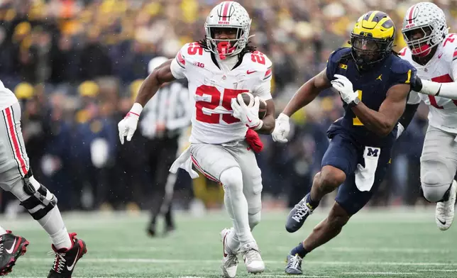 Ohio State running back Bo Jackson (25) runs the ball against Michigan linebacker Jaishawn Barham (1) during the first half of an NCAA college football game, Saturday, Nov. 29, 2025, in Ann Arbor, Mich. (AP Photo/Ryan Sun)