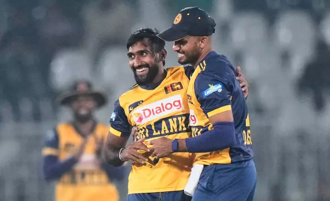 Sri Lanka's Eshan Malinga, left, celebrates with teammate after the dismissal of Zimbabwe's Brenden Taylor during the tri-series T20 cricket match between Sri Lanka and Zimbabwe, in Rawalpindi, Pakistan, Thursday, Nov. 20, 2025. (AP Photo/Anjum Naveed)